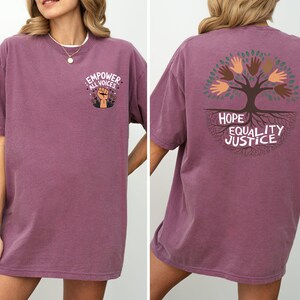 a woman wearing a purple shirt with a tree on it