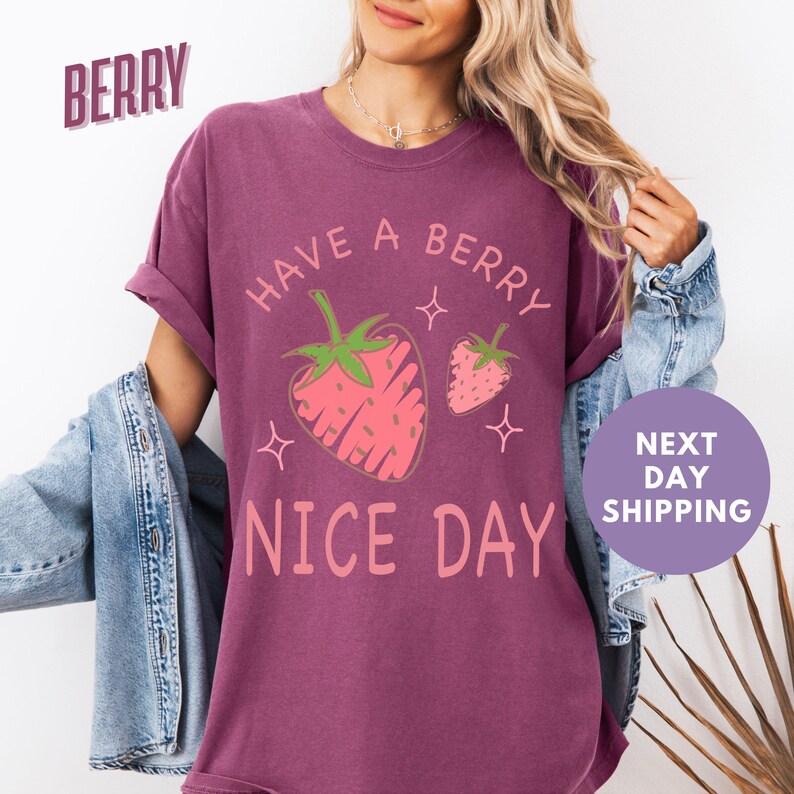 a woman wearing a berry nice day t - shirt
