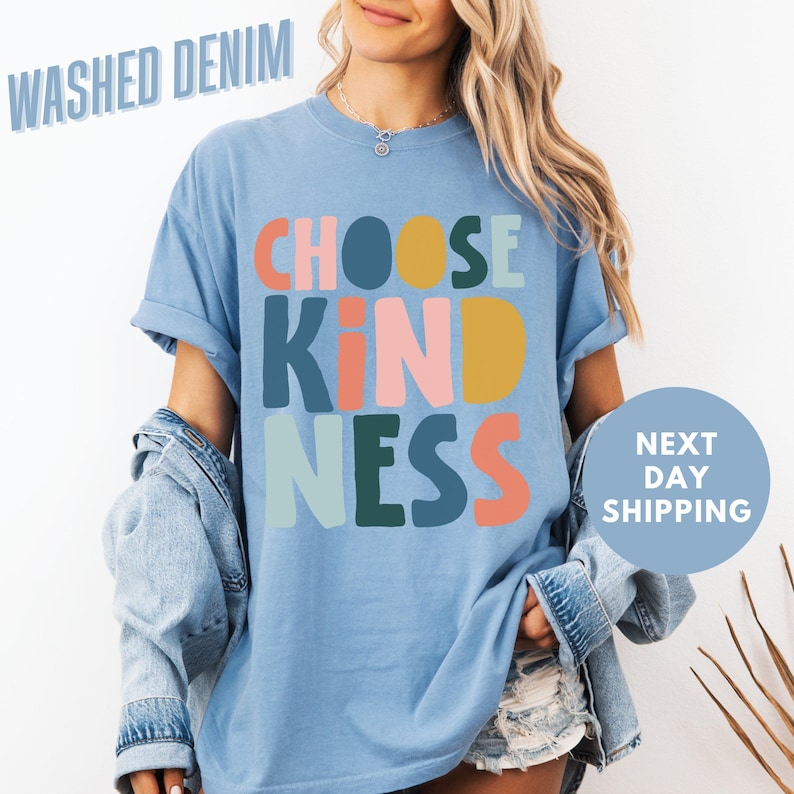 a woman wearing a blue t - shirt that says choose kind of nesss next