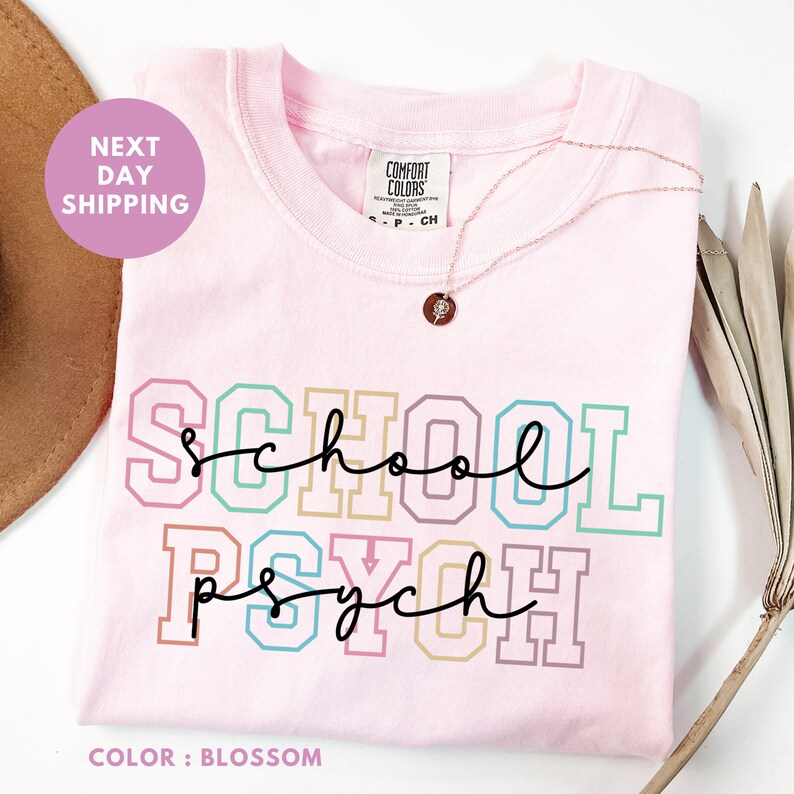 a t - shirt that says school is rough next to a hat