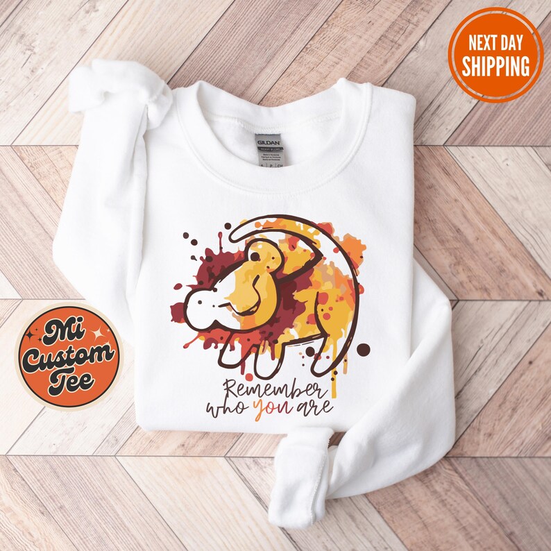 a white shirt with a lion on it