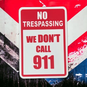 May include: Red and white sign with the text "NO TRESPASSING WE DON'T CALL 911" in black and red letters.