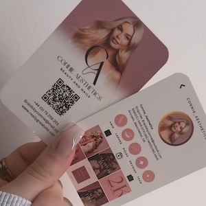 May include: Two business cards with rounded corners. The cards feature a woman's image and the text "CONNIE AESTHETICS BEAUTY AND NAILS". One card includes a QR code and contact information. The other card has social media icons and a profile picture.
