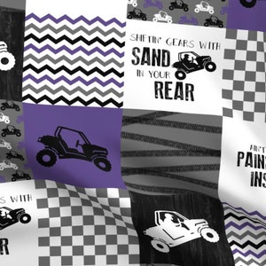 May include: A purple, black, white, and gray fabric with a checkered pattern, a chevron pattern, and a tire track pattern. The fabric features a repeated image of a black and white off-road vehicle. The fabric also features the text "Shiftin' Gears with Sand in Your Rear" and "Ain't No Pain When You're Driving Insane".