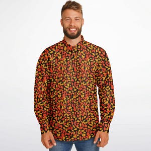 May include: A long-sleeved button-down shirt with a black background and a pattern of orange and yellow leaves.