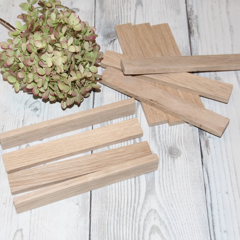 May include: A set of four unfinished wooden rectangular blocks, stacked on top of each other. The blocks are made of light-colored wood and have a smooth surface.