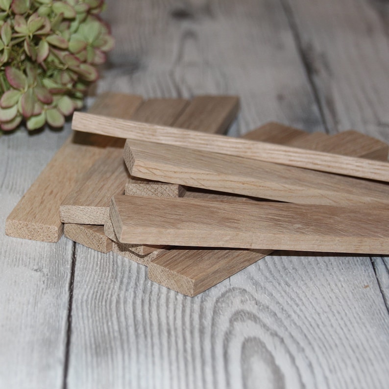 May include: A pile of unfinished, light brown wooden strips, likely for crafting or woodworking projects.