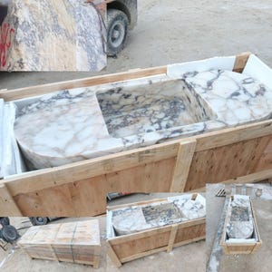 Collectible architectural marble sink made from rare Calacatta Viola marble, suspended luxury bathroom basin carved by hand from a massive stone block, floating vanity sink with dramatic sculptural presence designed for luxury villas and penthouses, premium handmade marble sink by MarbleSinkCo masters shipped worldwide with DHL Express