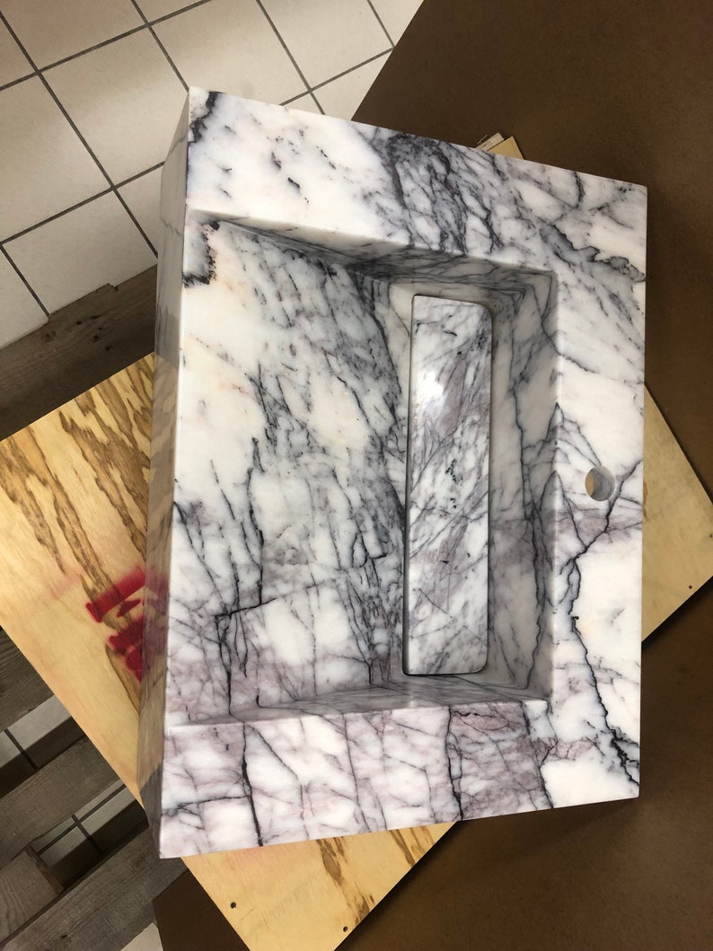 carrara-floating-sink-bathroom-visualization.jpg Styled bathroom visualization showing how the custom Carrara marble wall-mount sink may look after installation.