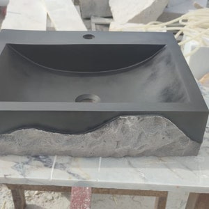🖤 Discover the timeless beauty of our handcrafted rectangular black lava stone sink, carved from natural volcanic basalt. Perfect for wall-mounted, countertop, or vessel installations. Each piece is uniquely veined and artisan-crafted for luxury bathrooms. A bold statement for modern interior design. Durable, water-resistant, and shipped worldwide in a protective wooden crate via DHL Express.