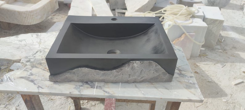 🖤 Discover the timeless beauty of our handcrafted rectangular black lava stone sink, carved from natural volcanic basalt. Perfect for wall-mounted, countertop, or vessel installations. Each piece is uniquely veined and artisan-crafted for luxury bathrooms. A bold statement for modern interior design. Durable, water-resistant, and shipped worldwide in a protective wooden crate via DHL Express.