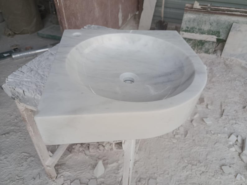 "Hand-carved Carrara marble sink – elegant, durable, and timeless. Perfect for luxury bathrooms, powder rooms, and boutique interiors. Custom sizes available: wall-mounted or countertop installation. Each piece features unique natural veining, adding character to your space. Discover our full collection of marble sinks, bathtubs, and stone accessories at MarbleSinkCo – follow us for more exclusive designs."
