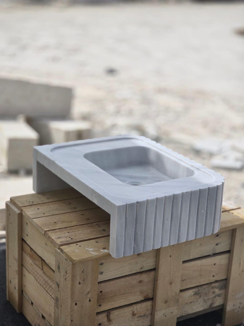 Elegant Bathroom Sink - Hand-Carved White Marble Bathroom Sink – Wall-Mounted or Countertop, Rectangular Vessel, Customizable Design - Close up of polished white marble sink bowl carved from a single block of natural stone ideal for modern and minimalist vanity designs