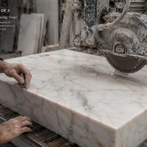 Finished Calacatta Gold marble sink inspected during quality control with measuring tools, polished basin, thick stone edges and handcrafted finish