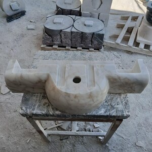 Luxurious wall-mounted Calacatta marble sink carved from a single block. Featuring 3 faucet holes, fluted front design, and floating vanity look. Ideal for modern, minimalist bathrooms. Custom sizes available. Handmade from natural Italian stone. Bathroom sink, marble vanity, stone basin, designer sink, fluted marble, wall mount sink, handmade sink, rectangular sink, luxury bathroom decor.