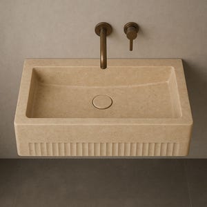 Handmade travertine wall-mounted sink with fluted front and matte finish. Custom sizes available. Ideal for luxury bathrooms, hotels, interior designers, and modern spa spaces. Each basin is carved from solid stone. Ships globally in a wooden crate via DHL Express. Natural veining varies uniquely in each piece.Perfect for minimalist,rustic,and architectural interiors, travertine wall-mounted sink,fluted front, solid stone, custom sizes,interior designers, modern spa, luxury bathrooms, minimalist