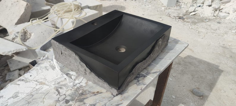 🖤 Discover the timeless beauty of our handcrafted rectangular black lava stone sink, carved from natural volcanic basalt. Perfect for wall-mounted, countertop, or vessel installations. Each piece is uniquely veined and artisan-crafted for luxury bathrooms. A bold statement for modern interior design. Durable, water-resistant, and shipped worldwide in a protective wooden crate via DHL Express.