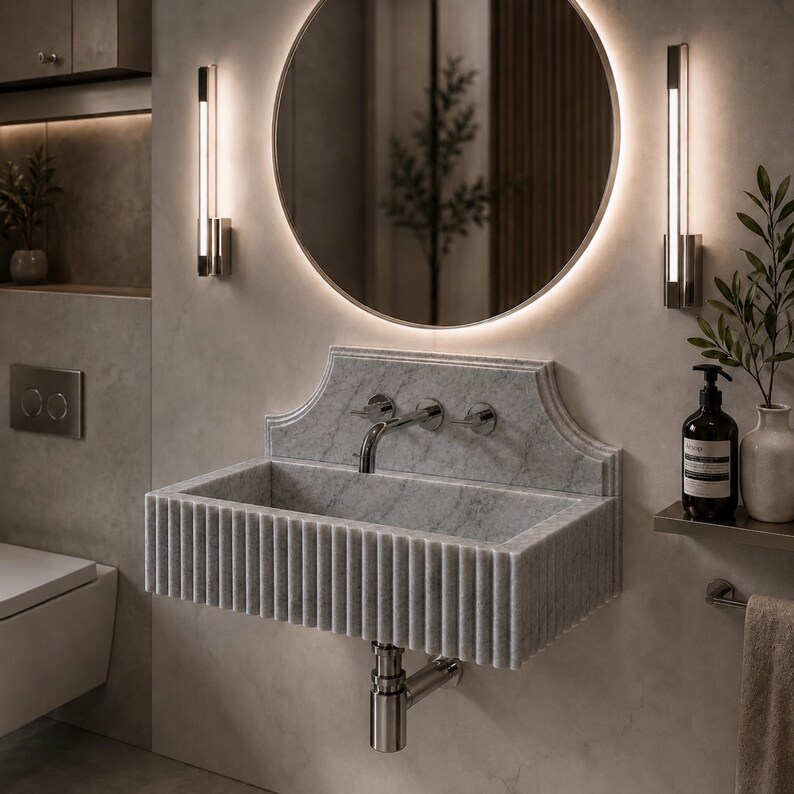 Luxury handcrafted Calacatta Viola marble floating wall mounted bathroom sink with sculptural fluted front and architectural backsplash in a premium designer bathroom.
