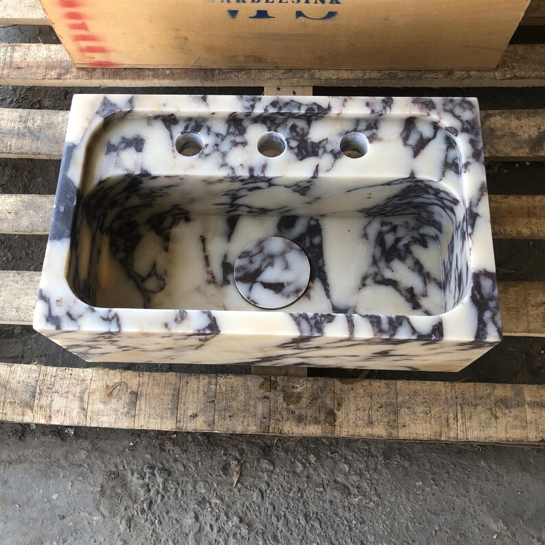 Top view of the handcrafted rectangular marble basin and central drain