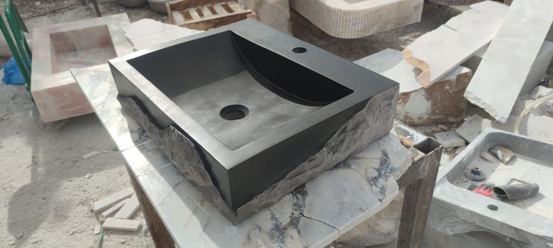 🖤 Discover the timeless beauty of our handcrafted rectangular black lava stone sink, carved from natural volcanic basalt. Perfect for wall-mounted, countertop, or vessel installations. Each piece is uniquely veined and artisan-crafted for luxury bathrooms. A bold statement for modern interior design. Durable, water-resistant, and shipped worldwide in a protective wooden crate via DHL Express.