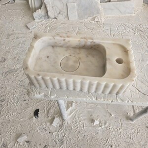 Handcrafted marble sink, Carrara marble basin, custom stone washbasin for bathroom, wall mounted and countertop vessel sink, natural stone vanity bowl, luxury bathroom design, Italian marble handmade sink, unique veined stone, elegant bathroom interior, artisanal stonework, real marble powder room sink, modern minimalist bathroom decor, durable and stylish marble sink, bathroom remodel ideas, hotel and yacht sink design