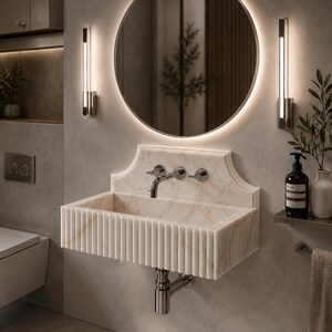 Luxury handcrafted Calacatta Viola marble floating wall mounted bathroom sink with sculptural fluted front and architectural backsplash in a premium designer bathroom.