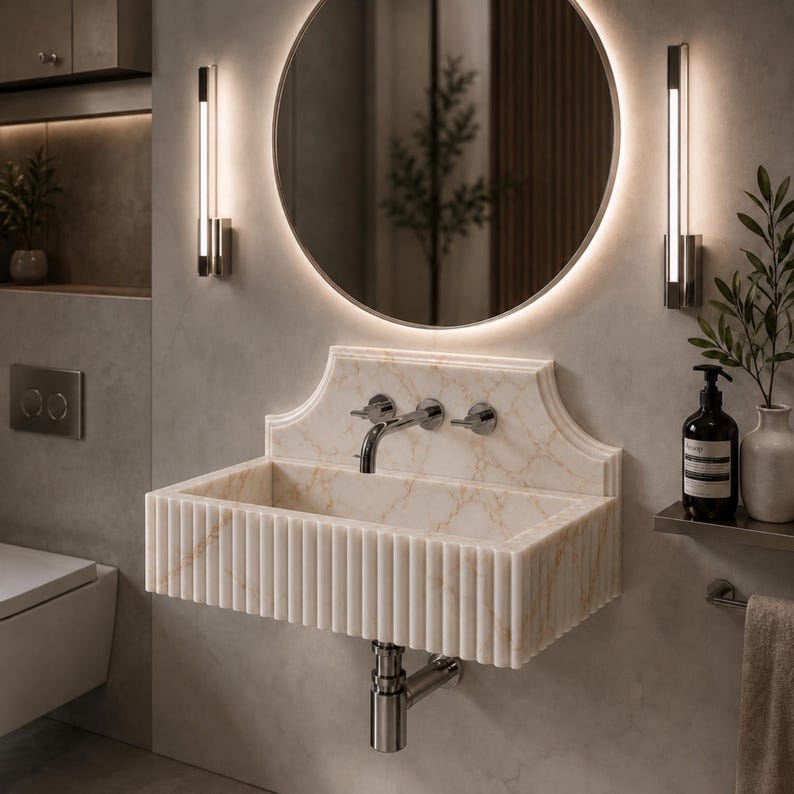 Luxury handcrafted Calacatta Viola marble floating wall mounted bathroom sink with sculptural fluted front and architectural backsplash in a premium designer bathroom.