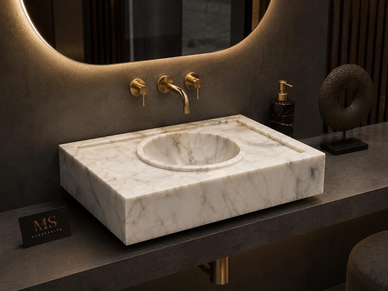Raw Calacatta marble block arriving at the stone workshop, lifted by crane and prepared for cutting into a luxury handmade bathroom sink