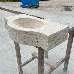 Hand-carved rectangular beige travertine countertop vessel sink with a smooth honed basin, rough chiseled exterior, centered drain and single faucet hole, custom-size natural stone bathroom washbasin by MarbleSinkCo.