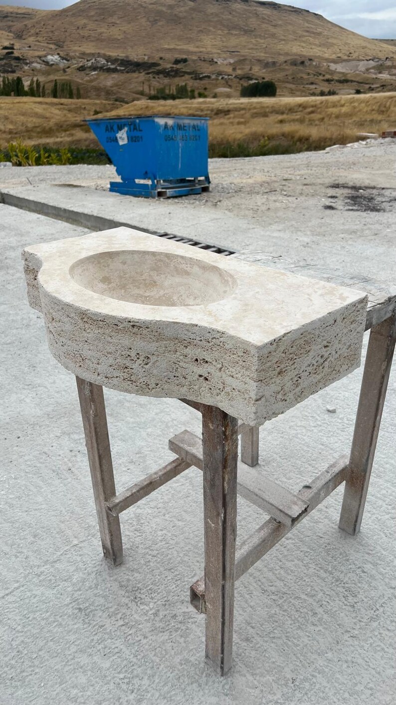 Hand-carved rectangular beige travertine countertop vessel sink with a smooth honed basin, rough chiseled exterior, centered drain and single faucet hole, custom-size natural stone bathroom washbasin by MarbleSinkCo.