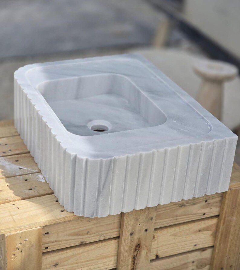 Elegant Bathroom Sink - Hand-Carved White Marble Bathroom Sink – Wall-Mounted or Countertop, Rectangular Vessel, Customizable Design - Close up of polished white marble sink bowl carved from a single block of natural stone ideal for modern and minimalist vanity designs