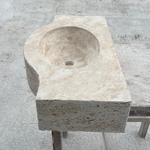 Hand-carved rectangular beige travertine countertop vessel sink with a smooth honed basin, rough chiseled exterior, centered drain and single faucet hole, custom-size natural stone bathroom washbasin by MarbleSinkCo.