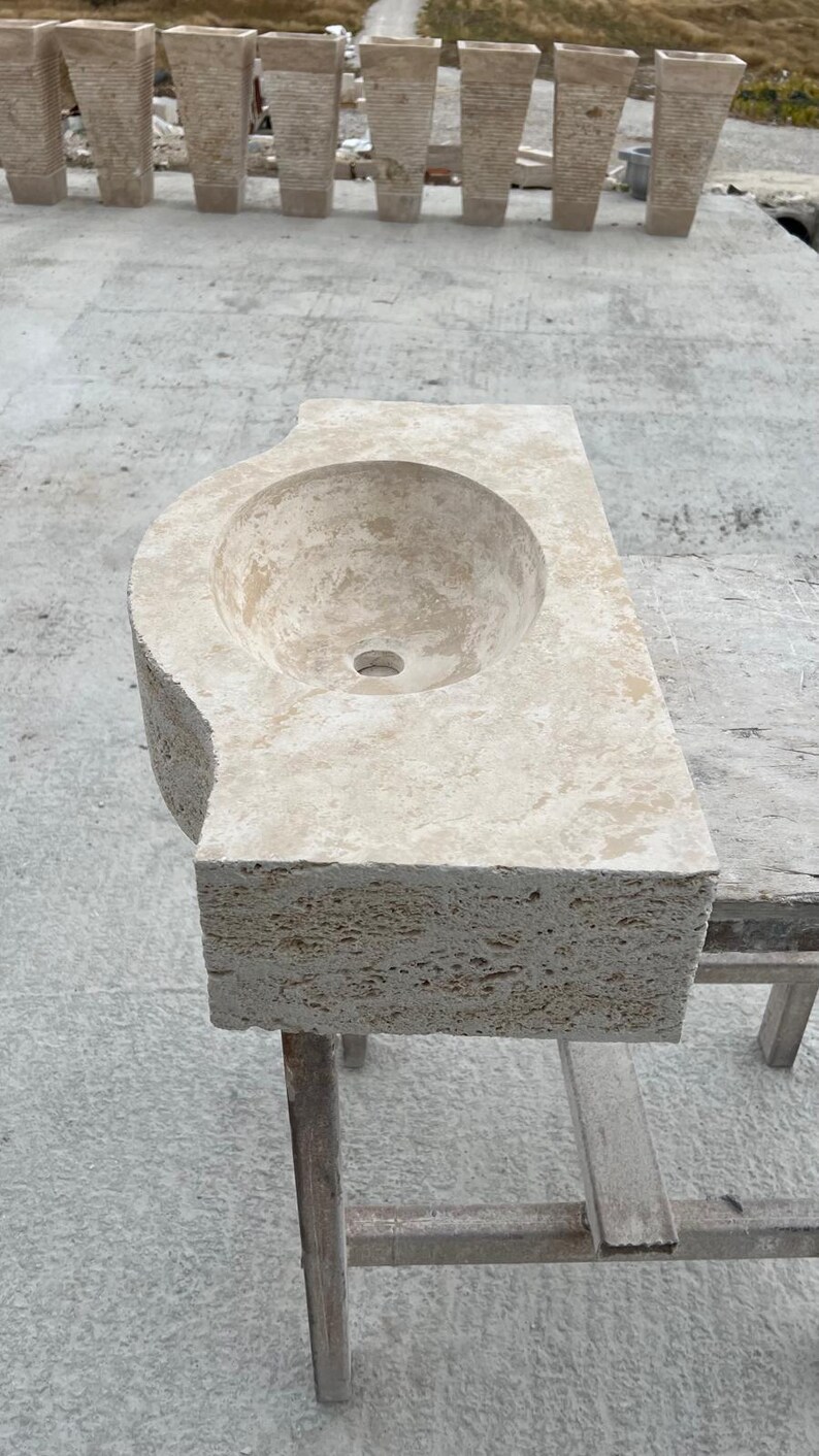 Hand-carved rectangular beige travertine countertop vessel sink with a smooth honed basin, rough chiseled exterior, centered drain and single faucet hole, custom-size natural stone bathroom washbasin by MarbleSinkCo.