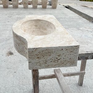 Hand-carved rectangular beige travertine countertop vessel sink with a smooth honed basin, rough chiseled exterior, centered drain and single faucet hole, custom-size natural stone bathroom washbasin by MarbleSinkCo.