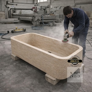 May include: A rectangular, light-colored wooden bathtub is being sanded by a person in a workshop. The tub is supported by wooden blocks. The image includes the text "ORIGINAL PRODUCT HIGH QUALITY".
