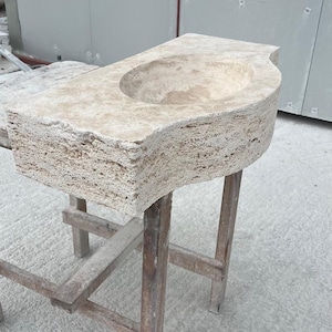 Hand-carved rectangular beige travertine countertop vessel sink with a smooth honed basin, rough chiseled exterior, centered drain and single faucet hole, custom-size natural stone bathroom washbasin by MarbleSinkCo.