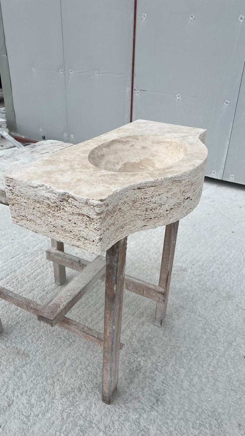 Hand-carved rectangular beige travertine countertop vessel sink with a smooth honed basin, rough chiseled exterior, centered drain and single faucet hole, custom-size natural stone bathroom washbasin by MarbleSinkCo.