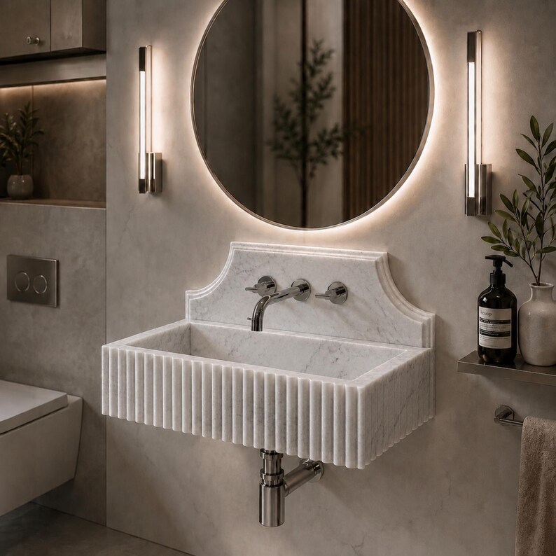 Luxury handcrafted Calacatta Viola marble floating wall mounted bathroom sink with sculptural fluted front and architectural backsplash in a premium designer bathroom.