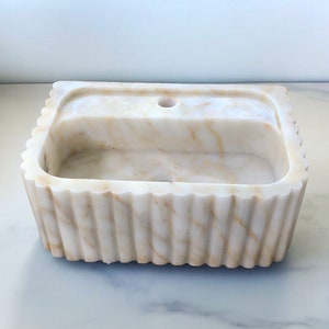 #HandCarvedSink #CalacattaViolaMarble #CustomizableVanityTop #CustomizableSink #BathroomSink #PowderRoomSink #FarmhouseSink #RareUniqueItem #WallMountSink #VesselSink #NaturalStoneSink #MarbleBathroomSink #LuxuryBathroomDecor #MarbleSinkCo