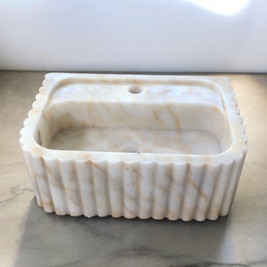 #HandCarvedSink #CalacattaViolaMarble #CustomizableVanityTop #CustomizableSink #BathroomSink #PowderRoomSink #FarmhouseSink #RareUniqueItem #WallMountSink #VesselSink #NaturalStoneSink #MarbleBathroomSink #LuxuryBathroomDecor #MarbleSinkCo