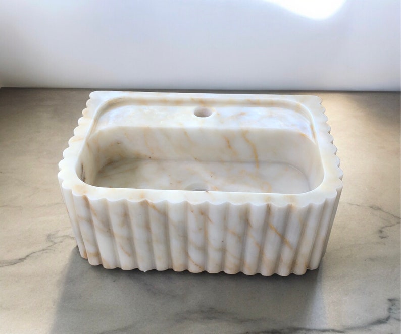 #HandCarvedSink #CalacattaViolaMarble #CustomizableVanityTop #CustomizableSink #BathroomSink #PowderRoomSink #FarmhouseSink #RareUniqueItem #WallMountSink #VesselSink #NaturalStoneSink #MarbleBathroomSink #LuxuryBathroomDecor #MarbleSinkCo