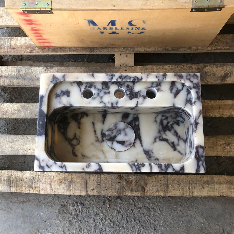 Marble bathroom sink protected inside a reinforced wooden shipping crate