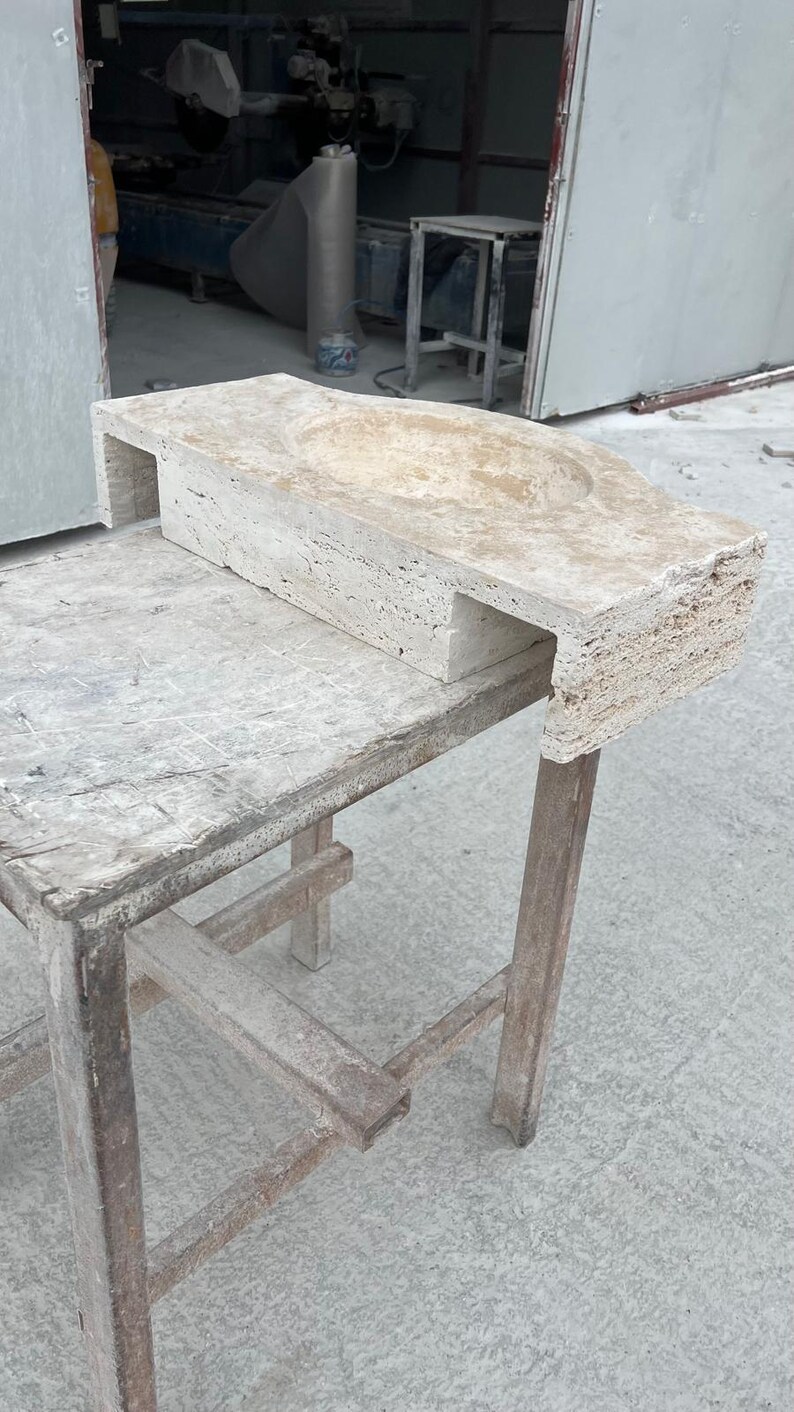 Hand-carved rectangular beige travertine countertop vessel sink with a smooth honed basin, rough chiseled exterior, centered drain and single faucet hole, custom-size natural stone bathroom washbasin by MarbleSinkCo.
