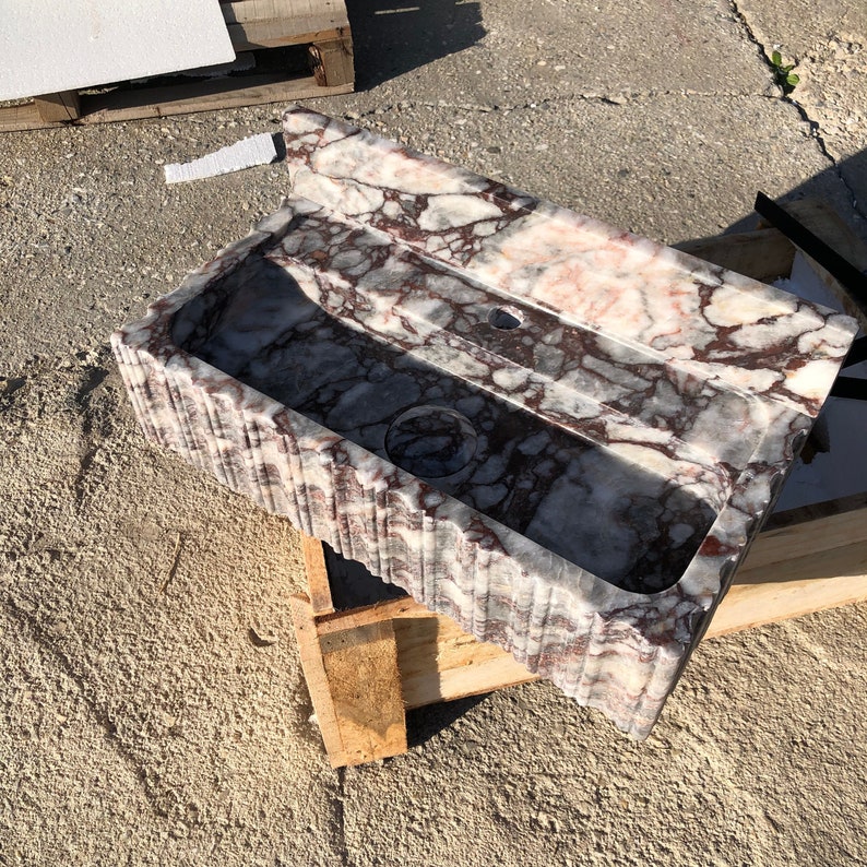Calacatta Viola marble wall mount sink handcrafted from real natural stone for luxury bathroom vanity, powder room design, boutique hotel bathroom, custom interior design project, purple burgundy veined marble basin