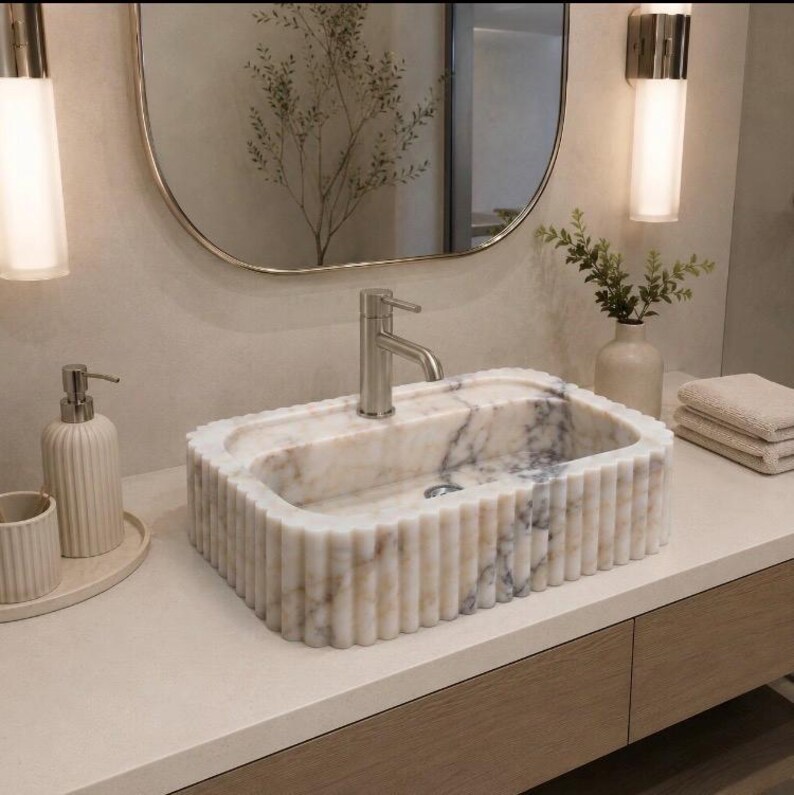 calacatta viola marble sink, fluted marble sink, grooved marble sink, wall mounted marble sink, wall hung stone basin, small powder room sink, compact bathroom sink, luxury powder room vanity, handcrafted marble basin, natural stone bathroom sink, custom marble sink, purple marble sink, burgundy marble sink, floating marble vanity, designer bathroom sink, boutique hotel bathroom sink, narrow bathroom sink, handmade stone sink, marble washbasin, architectural bathroom sink