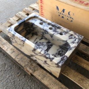 Finished Calacatta Viola marble sink with white stone and burgundy veining