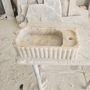 Handcrafted marble sink, Carrara marble basin, custom stone washbasin for bathroom, wall mounted and countertop vessel sink, natural stone vanity bowl, luxury bathroom design, Italian marble handmade sink, unique veined stone, elegant bathroom interior, artisanal stonework, real marble powder room sink, modern minimalist bathroom decor, durable and stylish marble sink, bathroom remodel ideas, hotel and yacht sink design