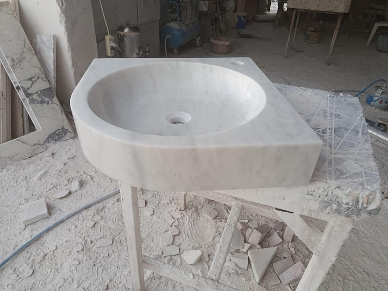 "Hand-carved Carrara marble sink – elegant, durable, and timeless. Perfect for luxury bathrooms, powder rooms, and boutique interiors. Custom sizes available: wall-mounted or countertop installation. Each piece features unique natural veining, adding character to your space. Discover our full collection of marble sinks, bathtubs, and stone accessories at MarbleSinkCo – follow us for more exclusive designs."