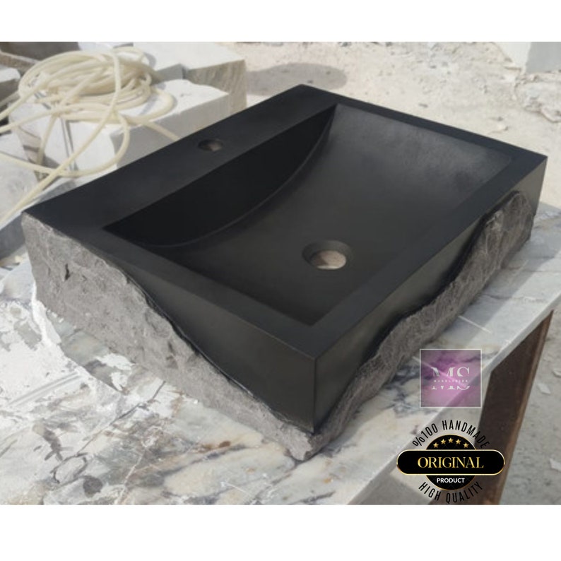 🖤 Discover the timeless beauty of our handcrafted rectangular black lava stone sink, carved from natural volcanic basalt. Perfect for wall-mounted, countertop, or vessel installations. Each piece is uniquely veined and artisan-crafted for luxury bathrooms. A bold statement for modern interior design. Durable, water-resistant, and shipped worldwide in a protective wooden crate via DHL Express.