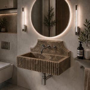 Luxury handcrafted Calacatta Viola marble floating wall mounted bathroom sink with sculptural fluted front and architectural backsplash in a premium designer bathroom.